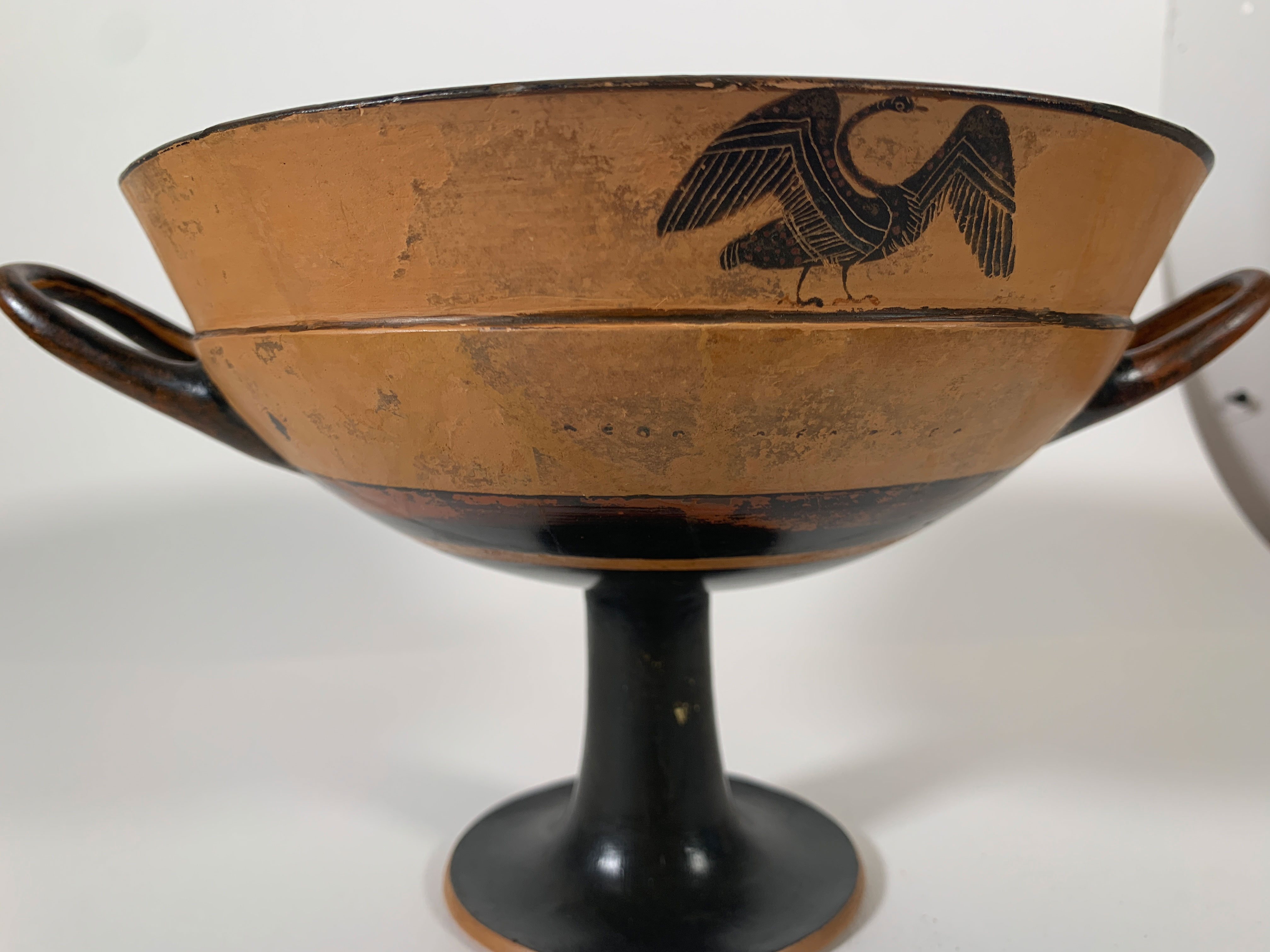 Side view showing swan and partially legible inscription